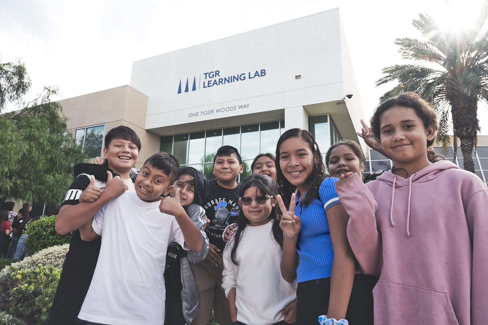 TGR Learning Lab students in front of building.
